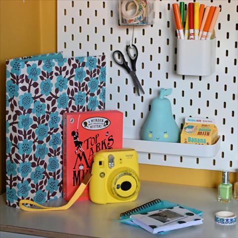 A desk area with colourful stationery