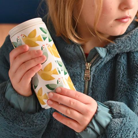 A young girl holds a Love Birds eco can