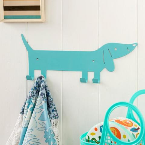 Blue metal wall hanger shaped like a sausage dog