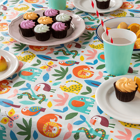 A party table set with cupcakes, colourful plates, cups, and festive decorations—ready for a celebration.
