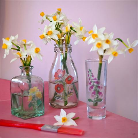 Three glass bottles decorated with decoupage