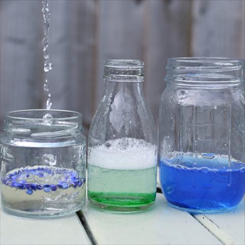 Jars filled with rain, food colouring and petals