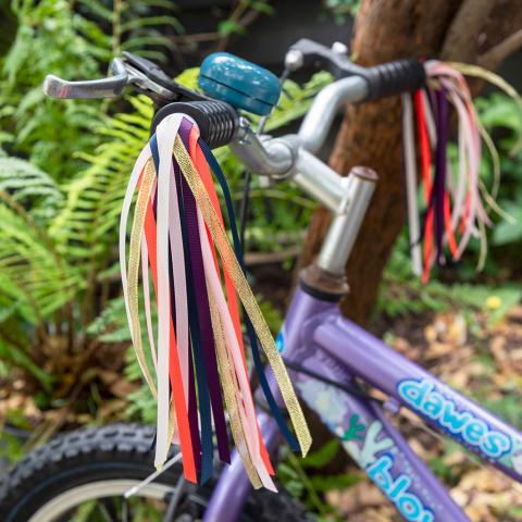 A bike with colourful streamers on the handles