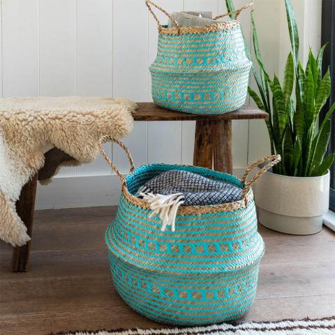 Two blue baskets with plant and bench