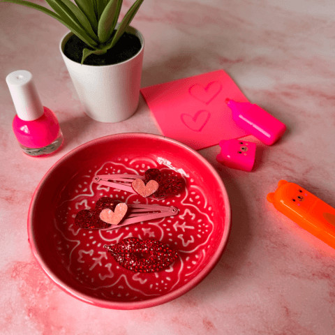 Hair clips and nail varnish with pink trinket tray