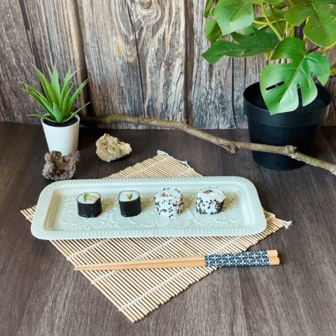 Sushi on tray with plant and chopstick