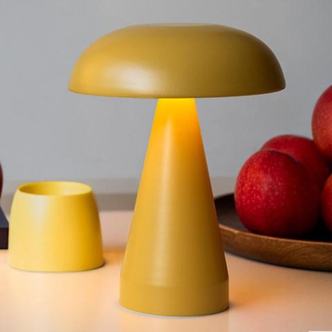 Yeloow lamp next to apples
