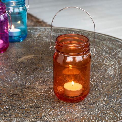 Tealight in orange holder outside