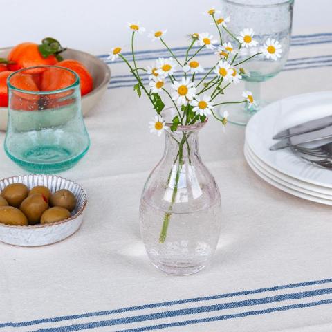 Vase with flowers on table
