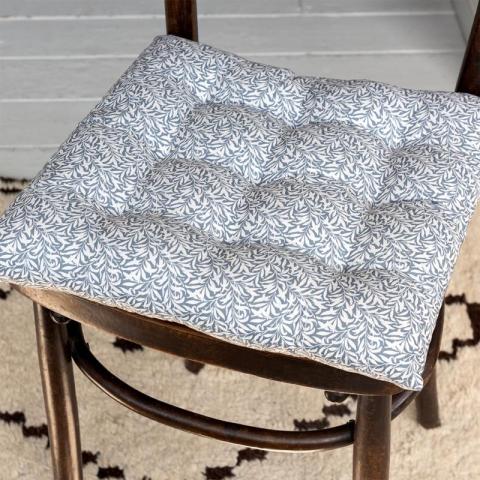 Grey cushion seat on brown chair inside