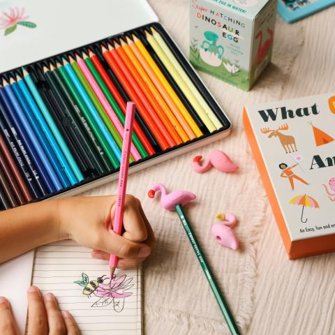 Child drawing with colouring pencils