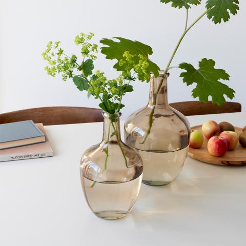 Vase with flowers on table