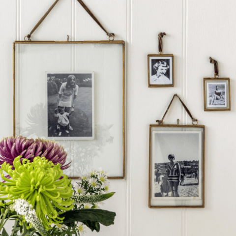 Retro photo frames on wall with flowers