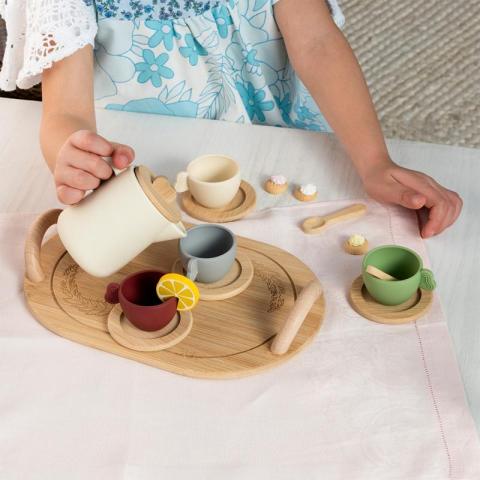 Wooden tea party set with child's hands