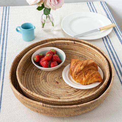 2 round trays with strawberries and a croissant