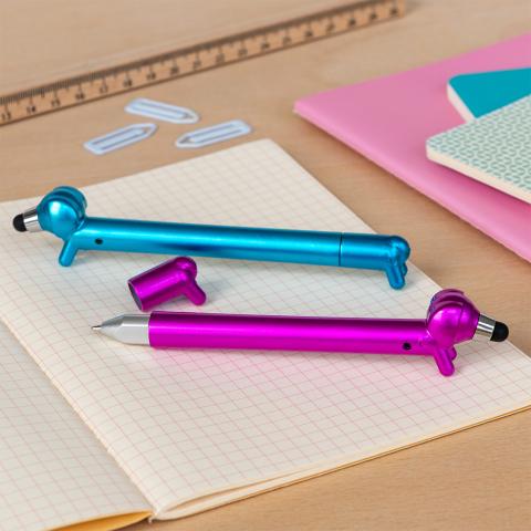 blue and pink sausage dog stylus ballpoint pen, lying on a notebook