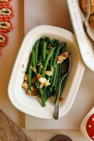 Green beans in white dish with spoon