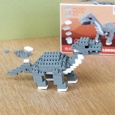 Grey dinosaur built with bricks with retro box in background