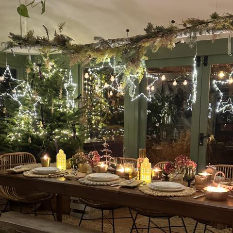 Lit up star with house decorations