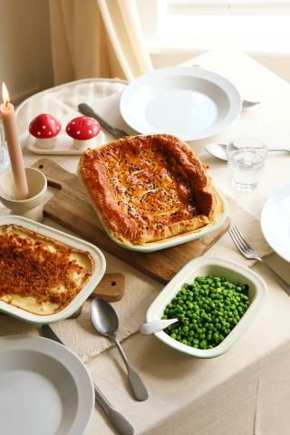 Pie with leeks and peas on dining table