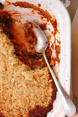 Veggie crumble in white dish with spoon