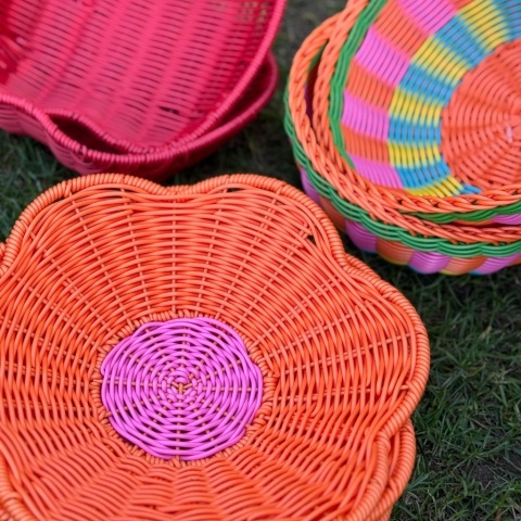 Brightly coloured baskets sit on a lawn