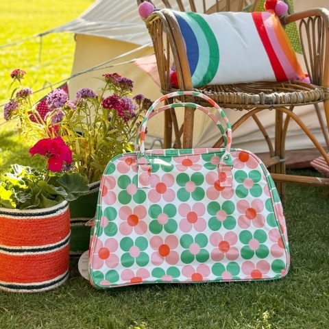 A large weekend bag with a pink and green floral print