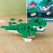 Close-up of a green Tyrannosaurus rex model built from small interlocking plastic bricks.