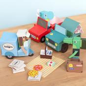 Colorful paper toy set with cars, trees, and accessories laid out on a wooden surface.