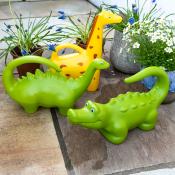 Brightly coloured animal‑shaped watering cans, including a dinosaur, giraffe and crocodile.