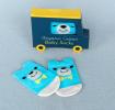 Pair of blue and white baby socks featuring bear face with yellow bow tie
