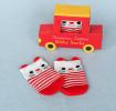 Pair of red and white striped baby socks featuring cat face