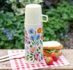 Small white stainless steel flask with cream plastic cup featuring floral pattern