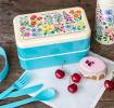 Turquoise plastic bento box with cream lid and middle tray featuring floral pattern