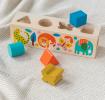 Wooden shape sorter toy featuring colourful illustrations of wild animals