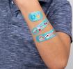 Light blue plasters with retro style top banana print on child's arm