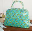 Turquoise oilcloth weekend bag with print of cheetahs