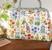 White oilcloth weekend bag with images of wild flowers