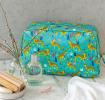 Turquoise oilcloth wash bag with print of cheetahs
