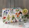 White oilcloth wash bag with wild flower pattern