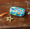 Light blue mini travel case with print of butterflies amongst flowers with accessories to fit inside