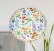 White paper lampshade with wild flower decoration installed in room