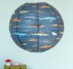 Dark blue paper lampshade with shark decoration installed in room