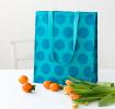 Recycled plastic shopping bag blue circles turquoise background