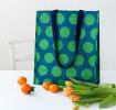 Recycled plastic shopping bag green circles dark blue background