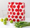 Recycled plastic shopping bag red circles cream background