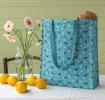 Turquoise shopping bag with print of bumblebees
