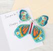 Blue magic butterfly toy placed inside greetings card