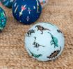 Pale blue inflatable ball with dinosaur print