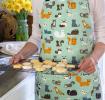 Nine Lives Recycled Cotton Apron worn by adult holding baked goods